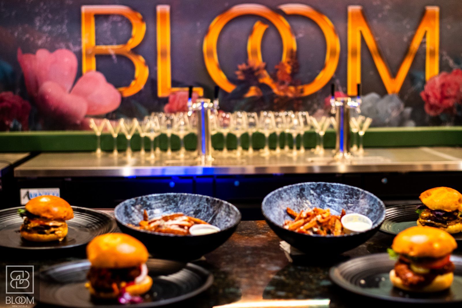 The gold BLOOM sign above the bar at BLOOM Southfield