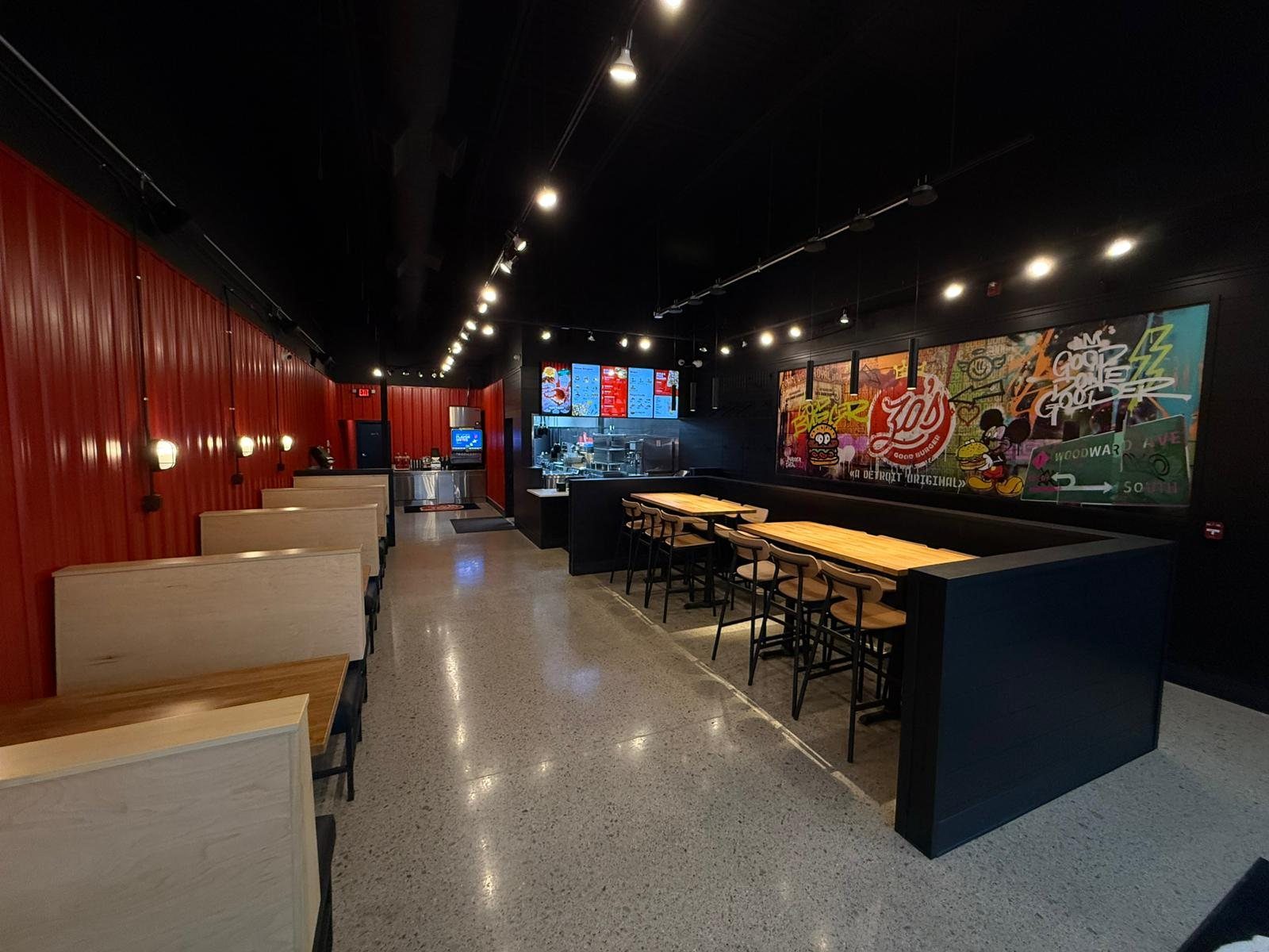 Zo's Good Burger dining room with red walls and booth seating