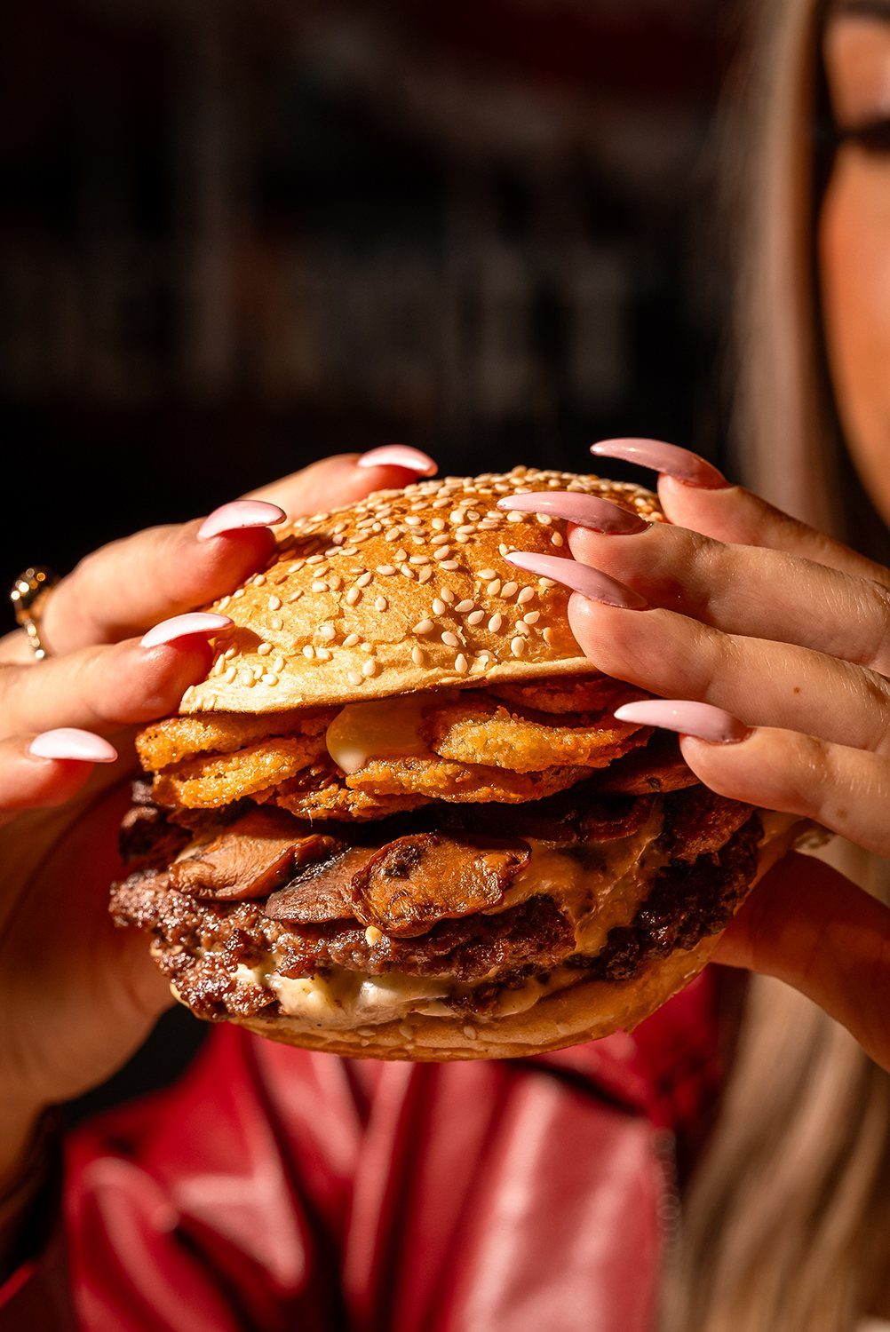 Hands holding a stacked Zo's mushroom burger