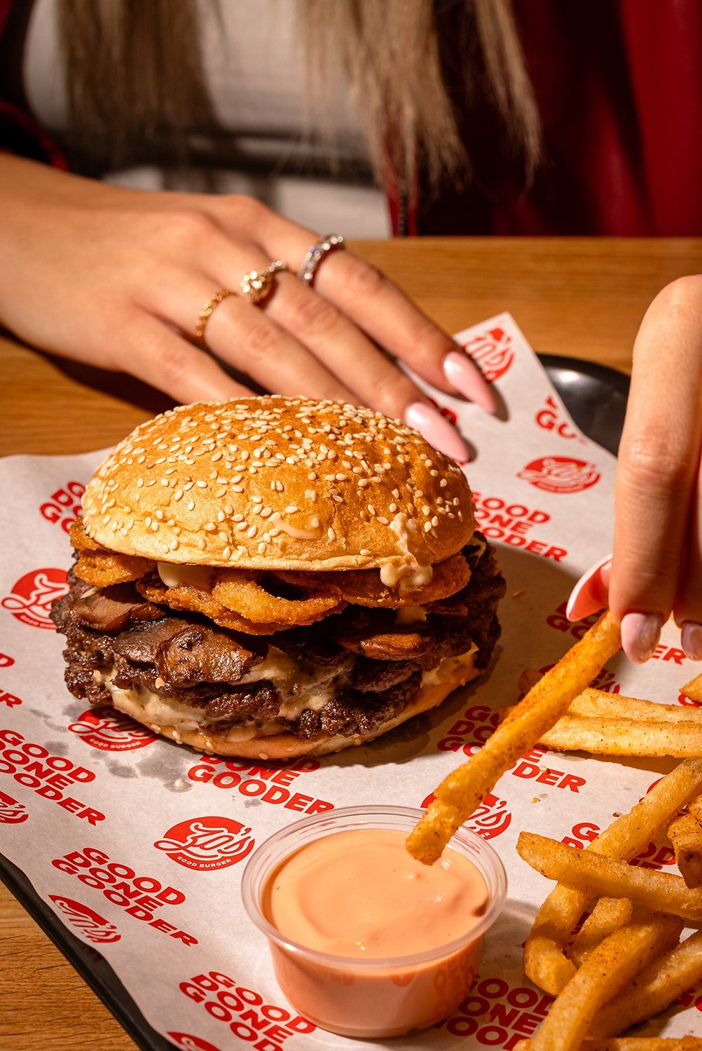 Zo's Good Burger smash burger with fries on branded paper